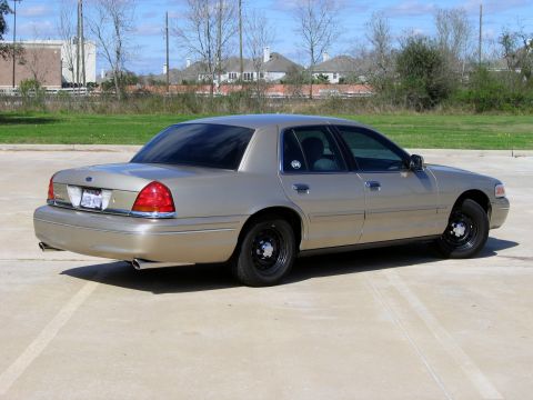 2000 Ford Crown Victoria - This 2000 Ford Crown Victoria is seen from the rear quarter angle, its tan exterior.