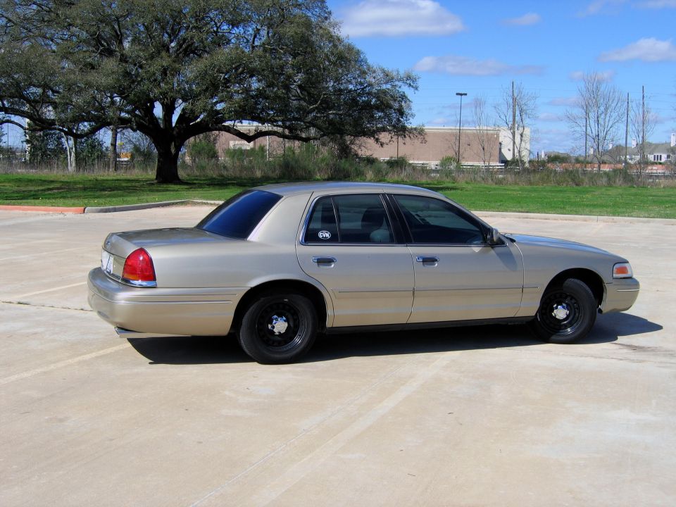 Gold 2000 Ford Crown Victoria parked outside