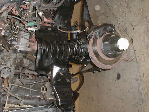 1991 Ford F-150 - Undercarriage view showing suspension, brake assembly, and engine bay wiring.
