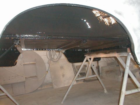 1991 Ford F-150 - Vehicle underbody being coated, supported by jack stands.