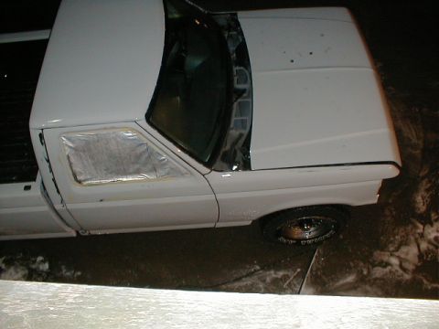 1991 Ford F-150 - A white 1991 Ford F-150 pickup truck is shown with its driver's side door open and the window covered with tape.