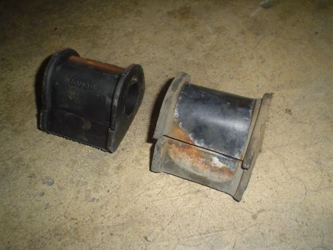 1993 Ford Taurus - These worn suspension bushings show signs of damage and rust, indicating they need replacement.