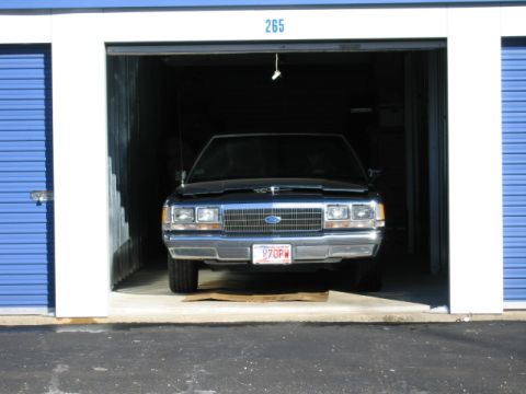 1991 Ford LTD Crown Victoria - A 1991 Ford Crown Victoria LTD is parked inside a storage unit, viewed from the front.
