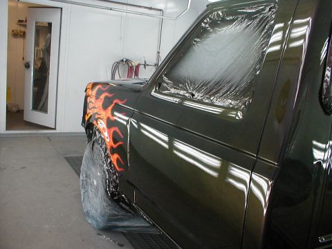1991 Ford F-150 - Truck fender with flame paint being prepped in a paint booth.
