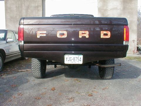 1991 Ford F-150 - Rear view of a 1991 Ford F-150 pickup truck with custom painted tailgate letters.