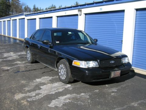 1991 Ford LTD Crown Victoria - Black 1991 Ford Crown Victoria LTD parked in front of blue storage unit doors.