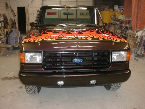 1991 Ford F-150 - This 1991 Ford F-150 features custom flame graphics on its hood and a dark brown metallic paint job.