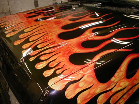 1991 Ford F-150 - Custom flame paint job covers the hood of a vehicle.