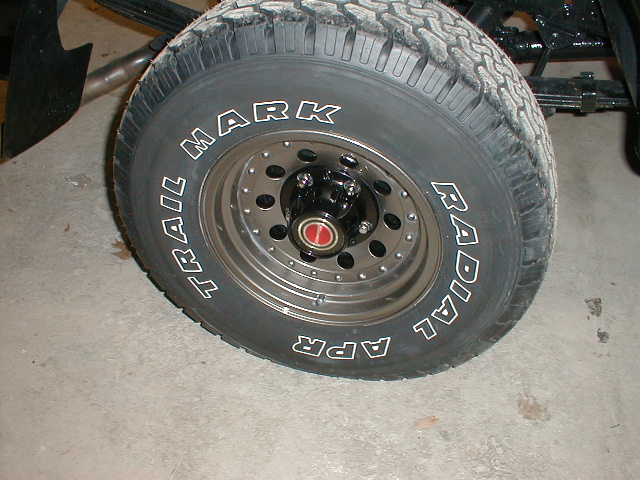 Close-up of a truck tire with 'TRAIL MARK' and 'RADIAL' written on the sidewall