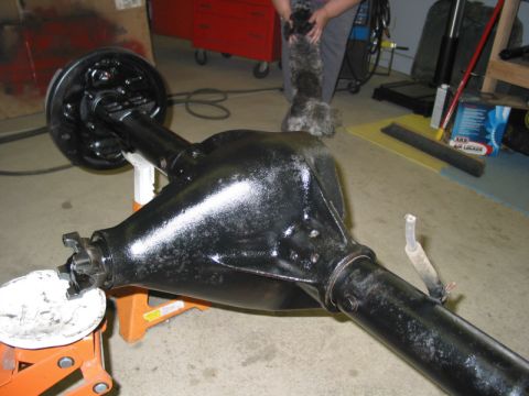 1981 Ford Bronco - A black rear axle assembly, likely from a truck or SUV, is shown on orange jack stands in a garage setting.