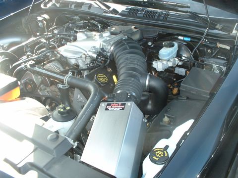 1999 Ford Crown Victoria - The engine bay of a vehicle is shown, the V8 engine and various components.