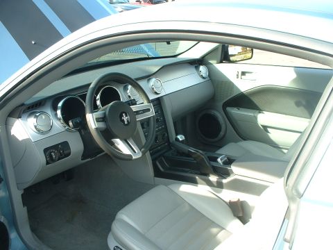 1999 Ford Crown Victoria - The interior of a Ford Mustang, likely from the mid-2000s, is shown with its distinctive dashboard and steering wheel.