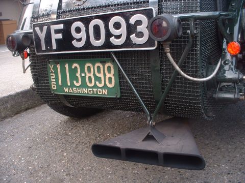 1999 Ford Crown Victoria - The rear of a vintage vehicle displays two license plates and a prominent quad exhaust pipe.