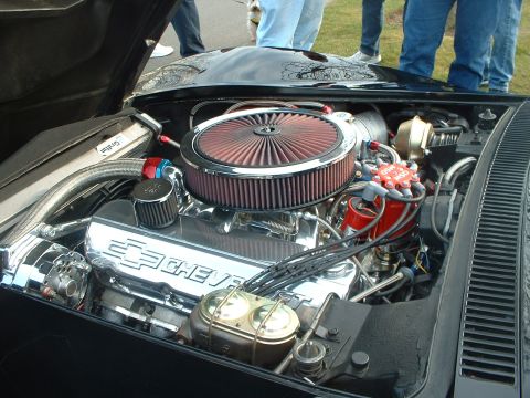 1999 Ford Crown Victoria - Close-up of a modified engine bay chrome Chevrolet valve covers and a large air filter.