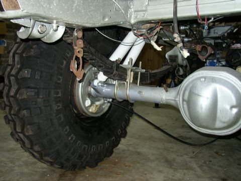 1995 Ford Bronco - Close-up view of the rear axle and suspension of a vehicle, showing heavy-duty components.