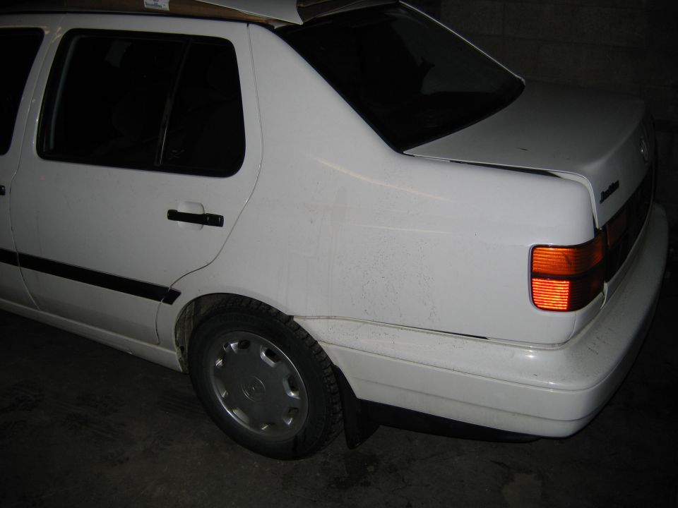 White sedan rear quarter view