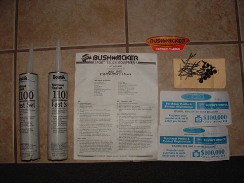 1993 Ford Bronco - Bushwacker fender flare kit includes sealant, instructions, hardware, and registration cards.
