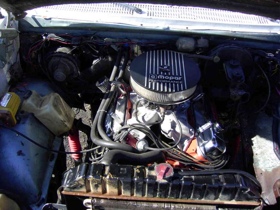 Orange Mopar V8 engine with Mopar Performance air cleaner and chrome valve covers