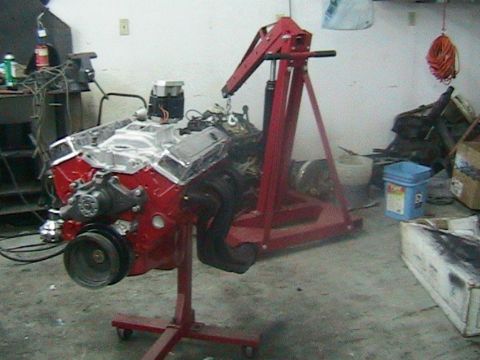 1981 Chevrolet C/K Pickup - Engine on a stand, likely for a project vehicle, in a workshop setting.