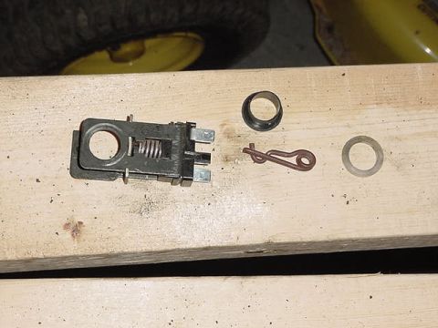 1995 Ford Bronco - Disassembled mechanical components and hardware laid out on a wooden surface.