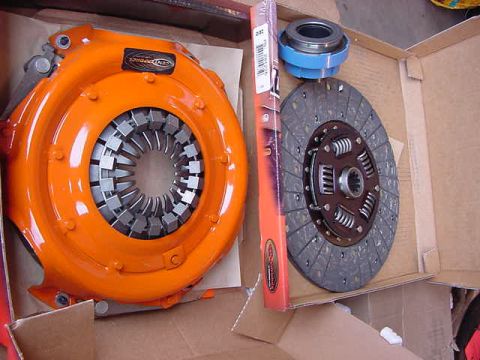 1995 Ford Bronco - A new clutch kit, including the pressure plate, disc, and bearing, is presented in its packaging.