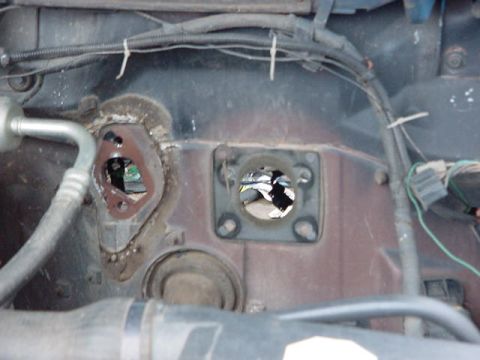 1995 Ford Bronco - Firewall openings in vehicle engine bay, with AC line and wiring visible.