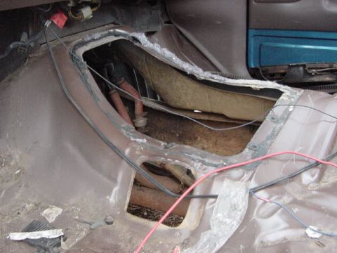1995 Ford Bronco - The interior floor pan and transmission tunnel are visible, with exposed wiring and some rust.