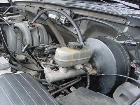 1995 Ford Bronco - Close-up view of the engine bay, focusing on the brake system components.