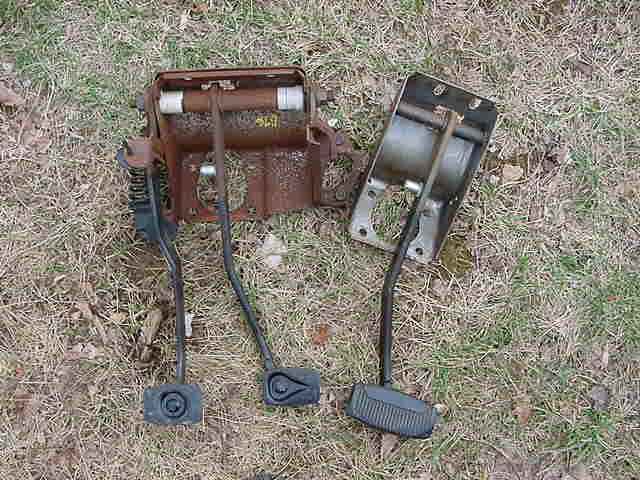 Rusty pedal assembly with three pedals on the ground