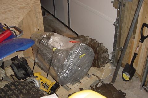 1995 Ford Bronco - Engine and transmission components are stored on a pallet, surrounded by various tools and equipment.