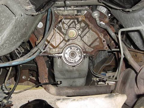 1995 Ford Bronco - Close-up view of an engine block and transmission bell housing, showing mechanical components and wiring.
