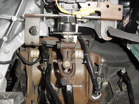 1995 Ford Bronco - Close-up view of the steering column and pedal assembly within a vehicle's interior.