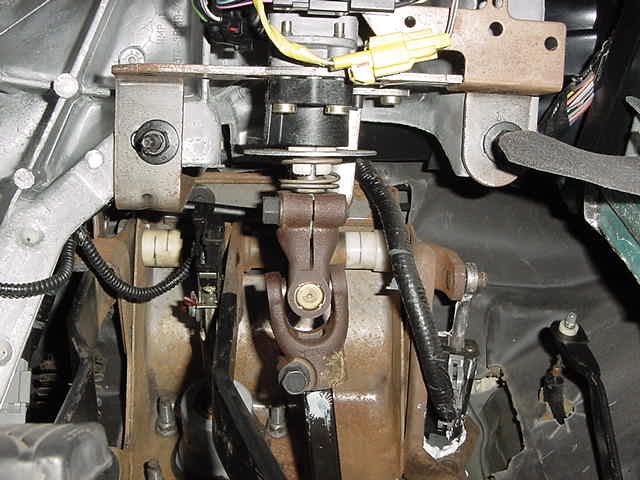 Steering column U-joint and pedals in a vehicle interior