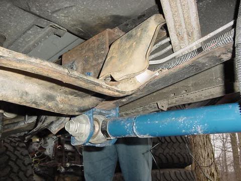 1995 Ford Bronco - A close-up view of the undercarriage reveals a blue pipe and various suspension components.