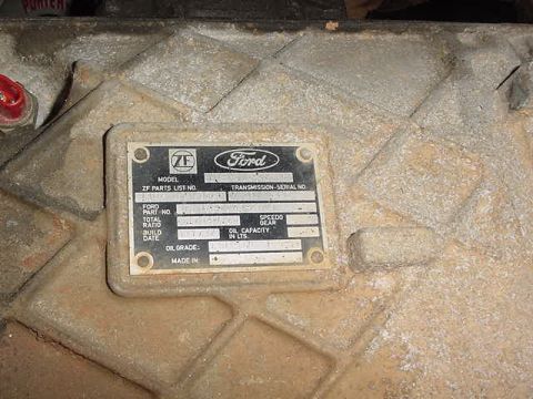 1995 Ford Bronco - A close-up of a transmission housing displays a Ford/ZF data plate with various part and capacity details.