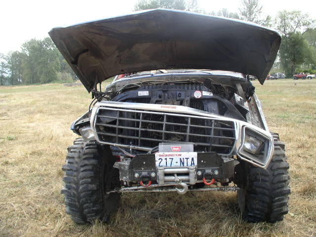 Modified 1978 Ford Bronco with hood open, large tires, and winch