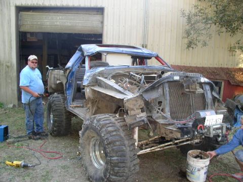 1979 Ford Bronco - A heavily modified 1979 Ford Bronco is shown with large off-road tires and a partially dismantled body, suggesting ongoing customization or…
