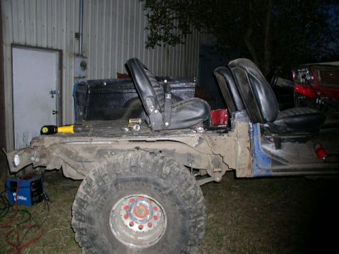 1979 Ford Bronco - This heavily modified SUV chassis, stripped down and with seats installed, appears to be undergoing significant work or customization.