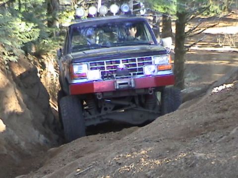 1994 Ford Explorer - Modified off-road vehicle tackles a challenging dirt path during an outdoor club event.