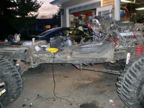 1979 Ford Bronco - This heavily modified vehicle frame is undergoing extensive work, with the engine and suspension components exposed.
