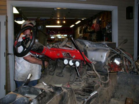 1979 Ford Bronco - Interior view of a vehicle undergoing modifications, showing dashboard components and a person working.