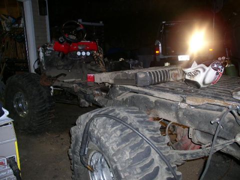 1979 Ford Bronco - Chassis of a custom off-road vehicle under construction, a prominent engine and oversized tires.