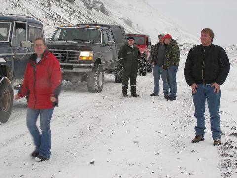 2001 Jeep Wrangler - A group of people stand with their off-road vehicles in a snowy, mountainous area.