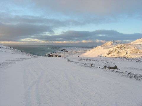 2001 Jeep Wrangler - A vast, snow-covered landscape meets the ocean under a cloudy sky.