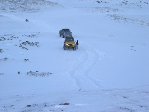 2001 Jeep Wrangler - Two vehicles, a Jeep and a pickup truck, navigate a snowy landscape.