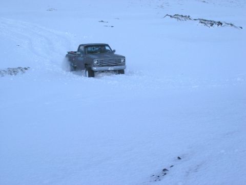2001 Jeep Wrangler - A dark pickup truck navigates through a snowy landscape, displaying styling cues from the 1980s.