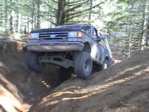 1994 Ford Explorer - A lifted Ford Bronco II tackles a challenging off-road course during a club outing.