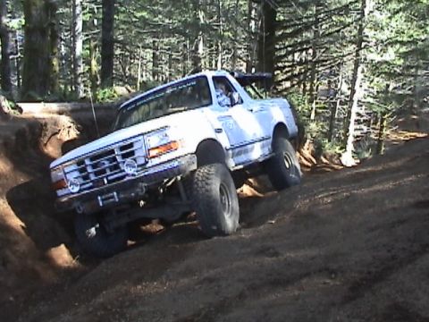 1994 Ford Explorer - Off-roading in a lifted 1994 Ford Bronco on a wooded trail.
