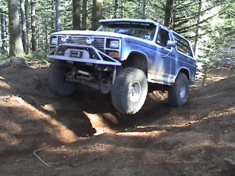 1994 Ford Explorer - This modified SUV navigates a challenging off-road course, its front tire lifted.