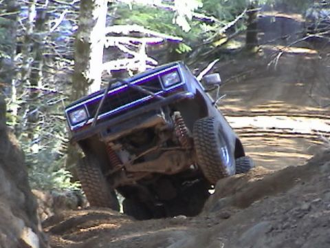 1994 Ford Explorer - A 1994 Ford Explorer navigates a steep, muddy trail during an off-road club event.